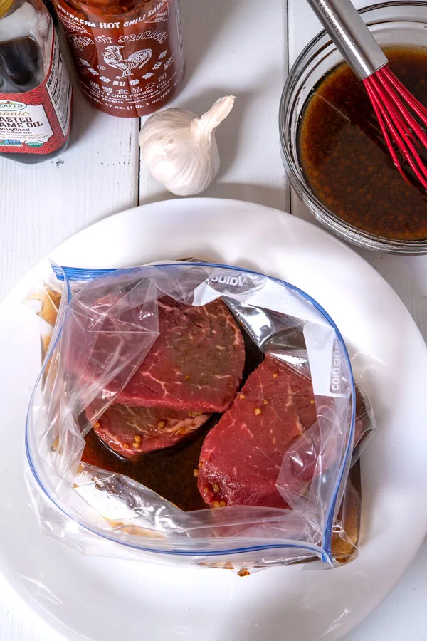 Steaks marinating in ziplock bag