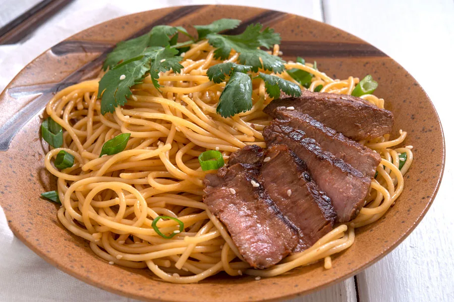 Plate of sesame noodles with sliced beef