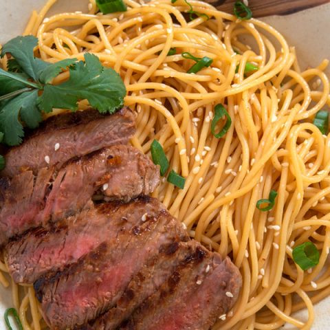 Plate of sesame noodles with sliced beef