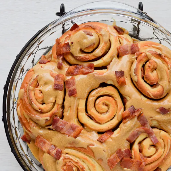 Maple bacon cinnamon rolls take the sweet and salty combo to new heights! Classic cinnamon rolls are stuffed with bacon and topped with a maple icing...plus more bacon!