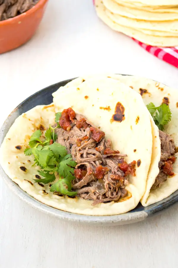 Authentic Mexican shredded machaca beef recipe in the crockpot. Delicious in tacos or with eggs!
