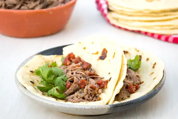 Authentic Mexican shredded machaca beef recipe in the crockpot. Delicious in tacos or with eggs!