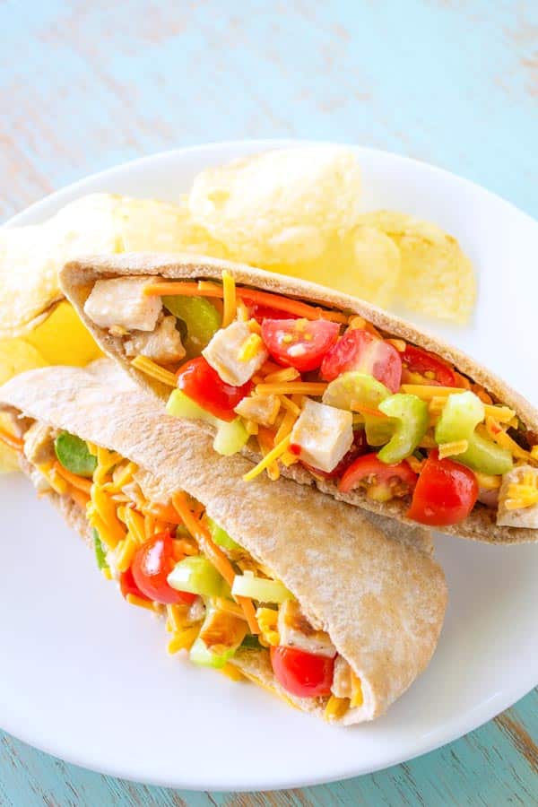 Chicken Veggie Pitas chock full of cheese, celery, carrots and tomatoes!