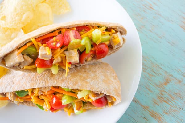 Chicken Veggie Pitas chock full of cheese, celery, carrots and tomatoes!
