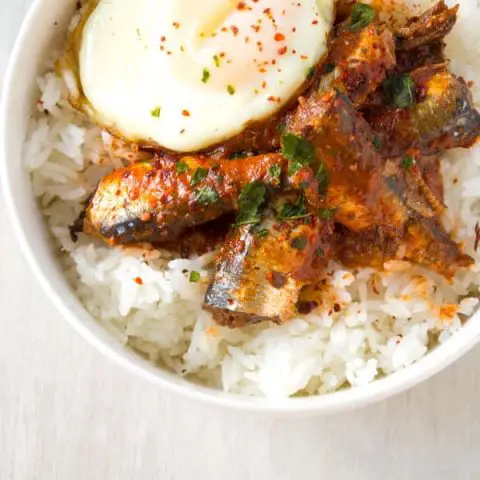 Healthy sardine rice bowl with canned sardines in tomato sauce. Skip the crackers and top with egg for an easy dinner!