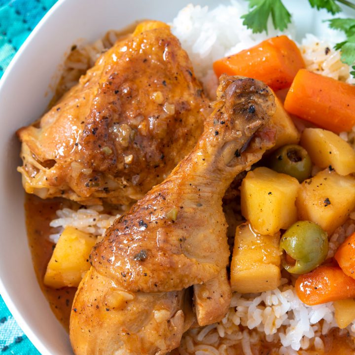 Plate of stewed chicken over rice