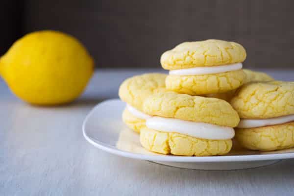 Velvety soft and chewy lemon sandwich cookies with tangy cream cheese frosting! They start with a cake mix and can be ready in 30 minutes!
