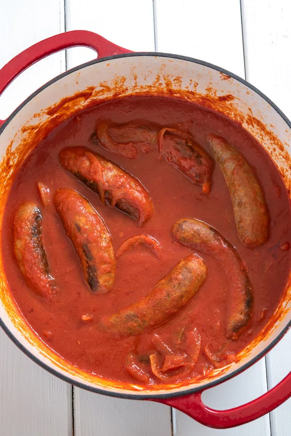 Pot of Italian sausages simmering in tomato sauce