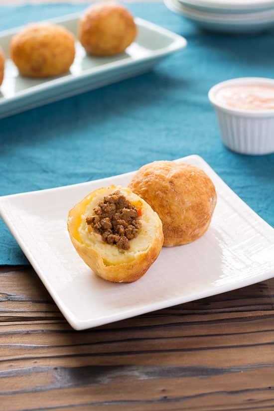 Puerto Rican Papas Rellenas - mashed potato croquettes filled with picadillo (ground beef hash) and fried to golden perfection! | Kitchen Gidget