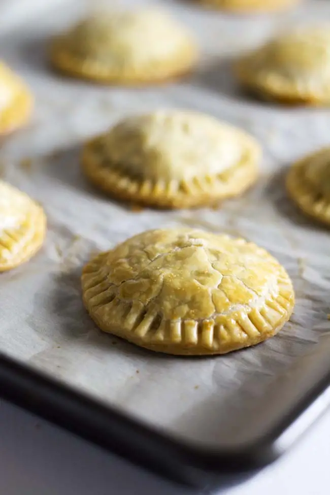 Cheesy beef and bean taco hand pies. Great party appetizer or alternative to Taco Tuesday! | Kitchen Gidget