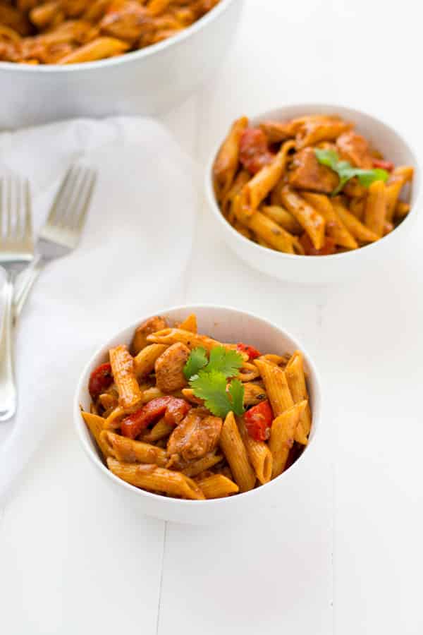 Puerto Rican Chicken Pasta: juicy bites of chicken, sautéed peppers and onions, and penne pasta to soak up a delicious sofrito-based broth! | Kitchen Gidget