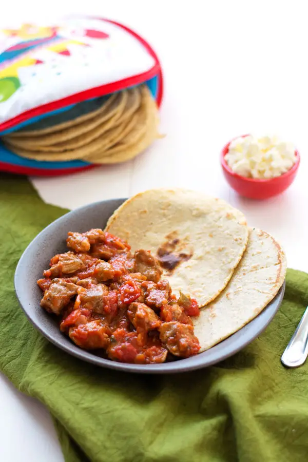 Mexican Pork Stew (Puerco en Salsa Roja) is an easy dinner with only 2 ingredients! Serve with homemade corn tortillas. | Kitchen Gidget