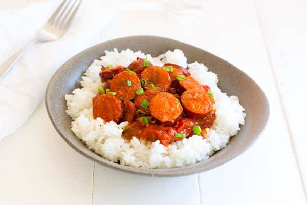 Smoked sausage creole is a riff on classic shrimp creole simmered in a simple sauce of tomatoes, peppers and onion. Serve with rice for an easy dinner! | Kitchen Gidget