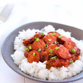 Smoked sausage creole is a riff on classic shrimp creole simmered in a simple sauce of tomatoes, peppers and onion. Serve with rice for an easy dinner! | Kitchen Gidget