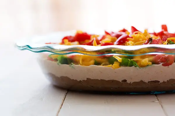 Fiesta Bean Dip - this layered taco dip is a huge hit at parties! | Kitchen Gidget