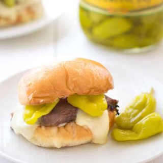 These delicious steak sandwiches start with grilled peperoncini beef marinated in a zesty pepper sauce, then smothered in mozzarella cheese!
