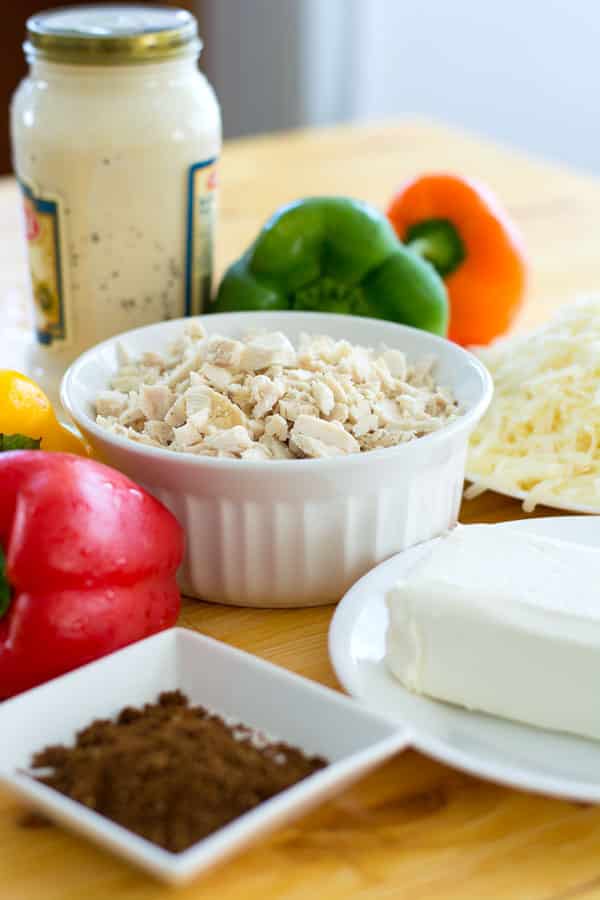 Cajun Chicken Alfredo Dip with cream cheese, mozzarella, chicken and spice. Only five ingredients in this super cheesy dip with a creole kick!