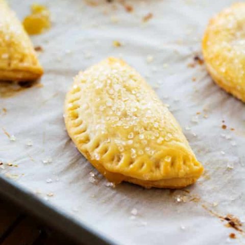 These tasty little pineapple empanadas are a breeze to make with only three ingredients in the crust and pineapple preserves for the filling! Easy breakfast or dessert!