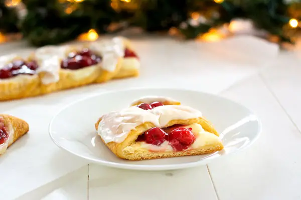 Christmas Breakfast Danish: cherry cheese pastry in candy cane shape! Easy to make with crescent rolls, cherry pie filling and cream cheese.