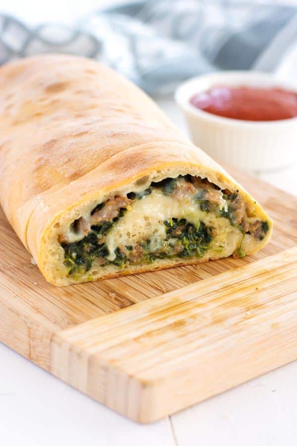Loaf of rolled spinach and sausage bread