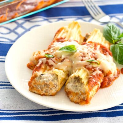 plate of manicotti with sauce and cheese
