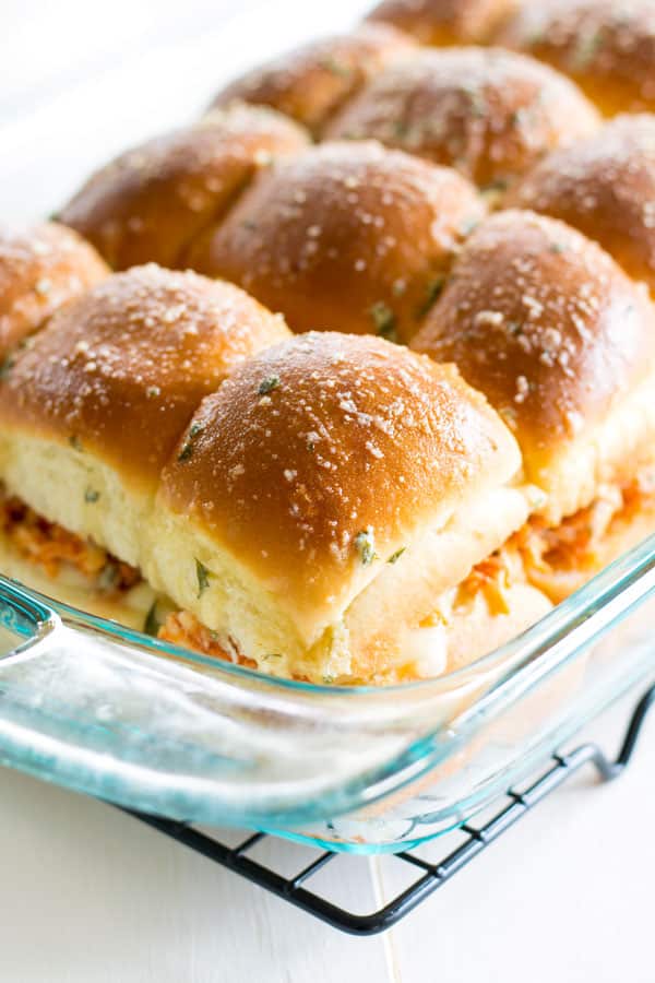 Pan of Slow Cooker Chicken Parmesan Sliders with garlic butter topping