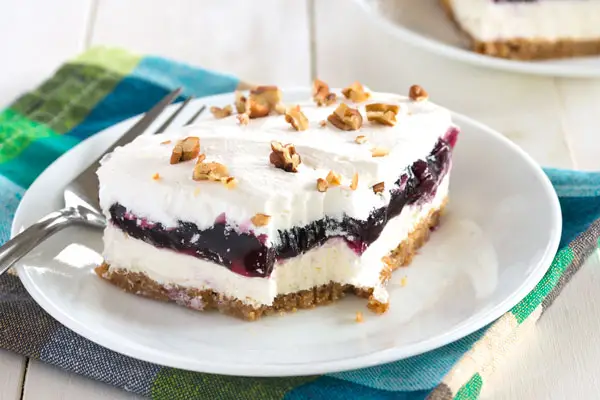 Blueberry Delight with graham cracker crust - cheesecake meets blueberry fluff in this no bake dessert!