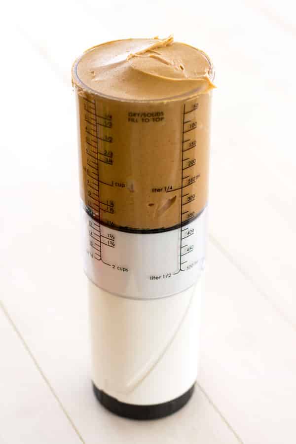 Peanut butter in adjustable measuring cup for monster cookies