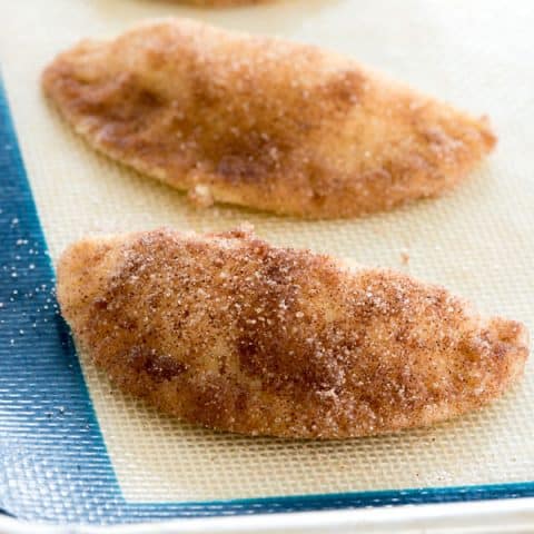 Mini sopapilla cheesecakes dipped in cinnamon sugar ready for baking! #empanadas #cheesecake