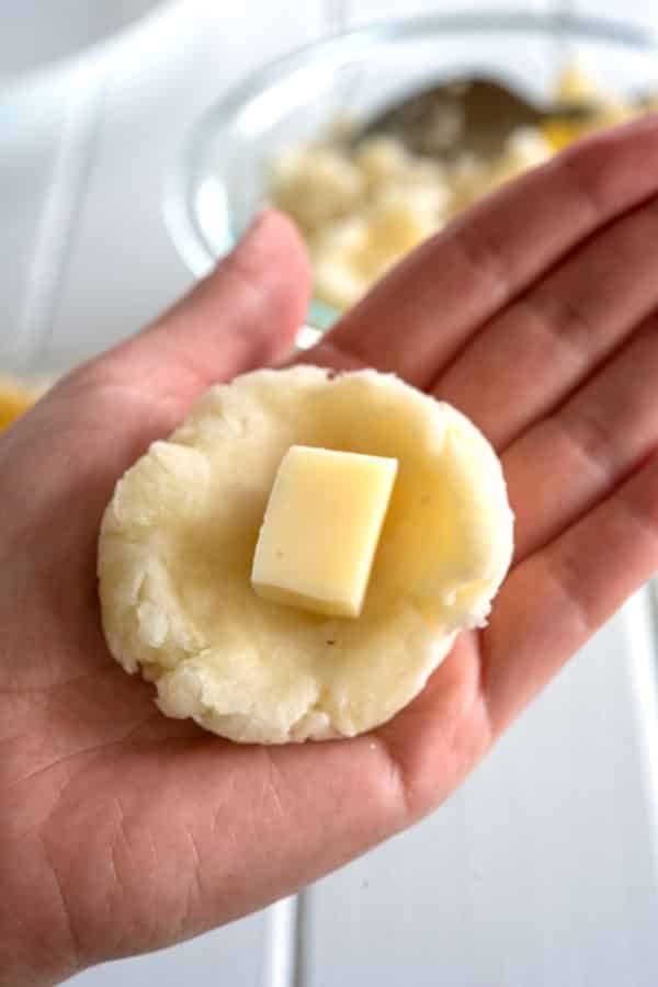 Mashed yuca being stuffed with cheese for Bolitas de yuca