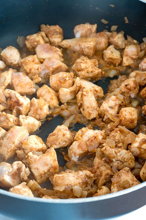 Sauteed cubes of chicken for enchilada pasta
