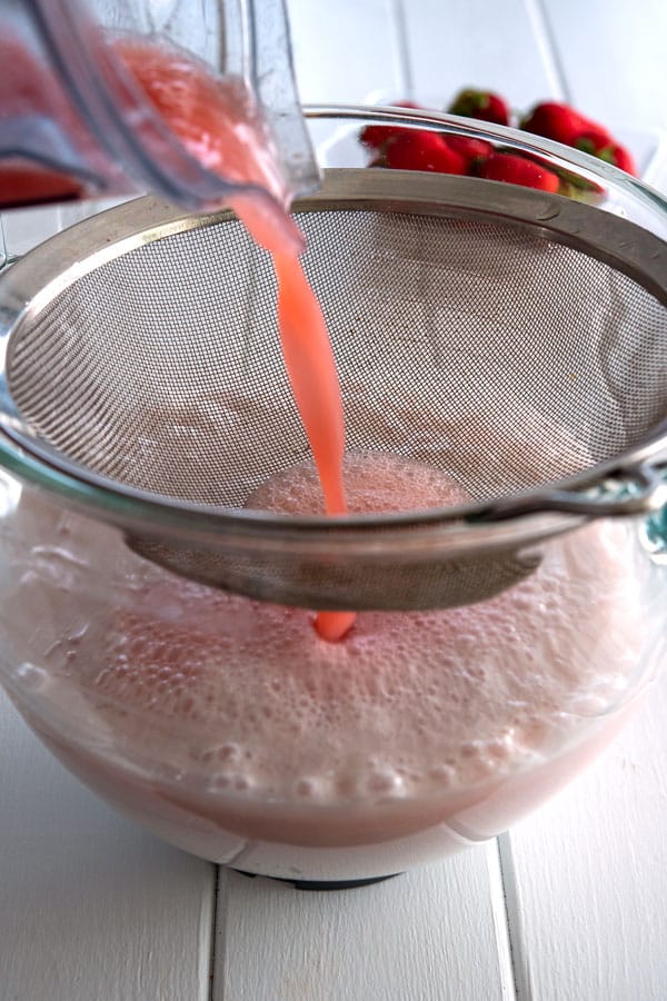 Strawberry puree being strained for 