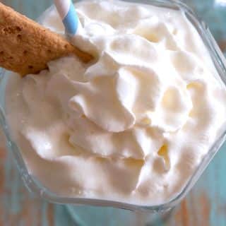 Overhead shot of a cheesecake milkshake without ice cream topped with whipped cream!