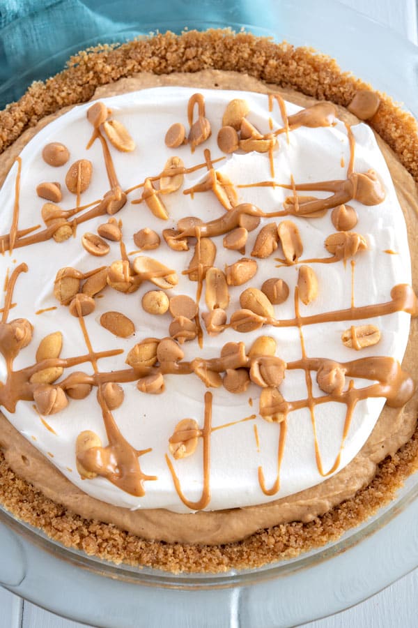No Bake Peanut Butter Pie topped with cool whip and peanuts