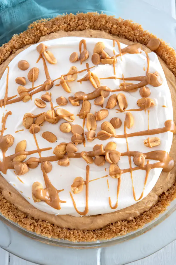 No Bake Peanut Butter Pie topped with cool whip and peanuts