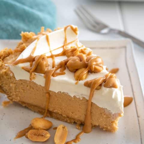 Slice of No Bake Peanut Butter Pie with graham cracker crust, cream cheese and cool whip