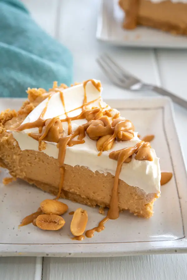 Slice of No Bake Peanut Butter Pie with graham cracker crust, cream cheese and cool whip