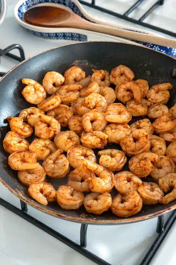 Cooking shrimp in a pan for shrimp tacos
