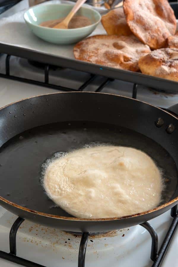 Flour tortilla frying in oil for Easy Buñuelos Recipe