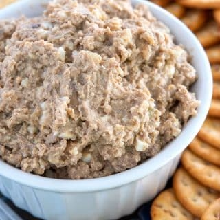 Small crock of chicken liver pâté with a plate of crackers