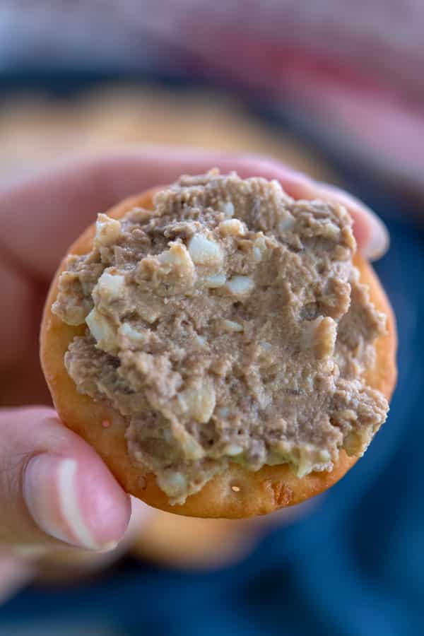 Close up shot of one cracker topped with chicken liver pâté