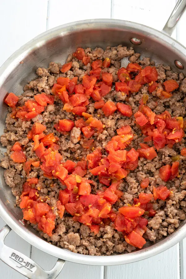 Sausage and Rotel cooking in skillet for sausage cream cheese dip