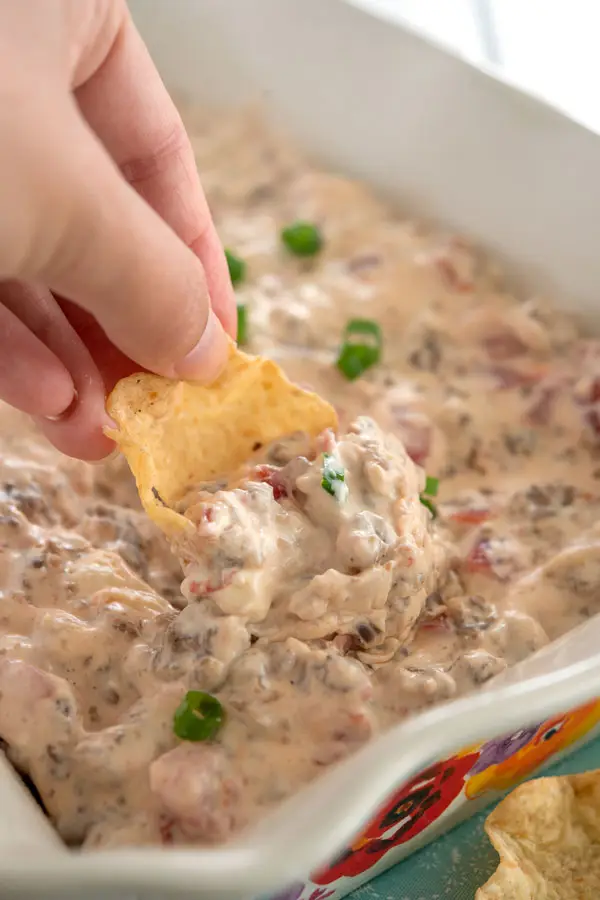 Tortilla chip scooping up sausage cream cheese dip