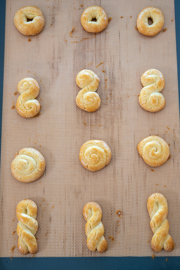 Cookie sheet of baked Greek koulourakia cookies