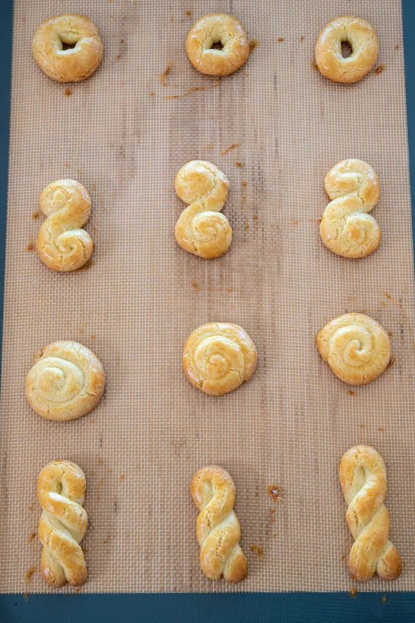 Cookie sheet of baked Greek koulourakia cookies