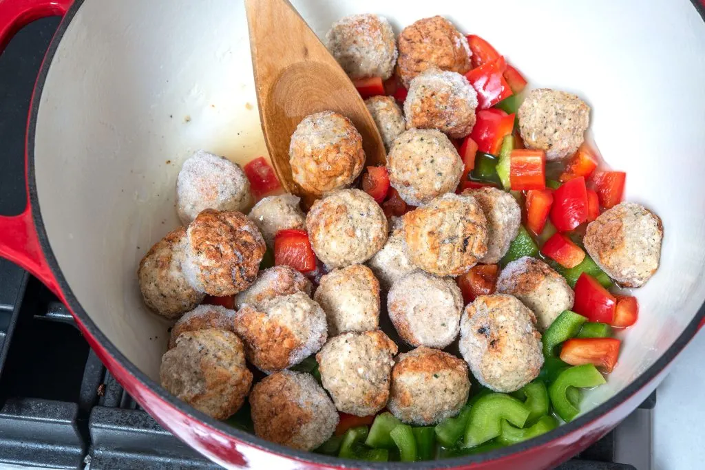 Ingredients for sweet and sour meatballs cooking in a pot