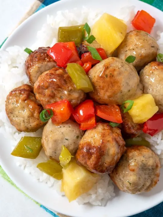 Overhead view of sweet and sour meatballs with rice on a plate