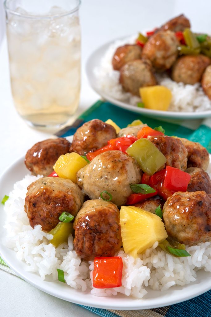 Plate of sweet and sour meatballs over rice